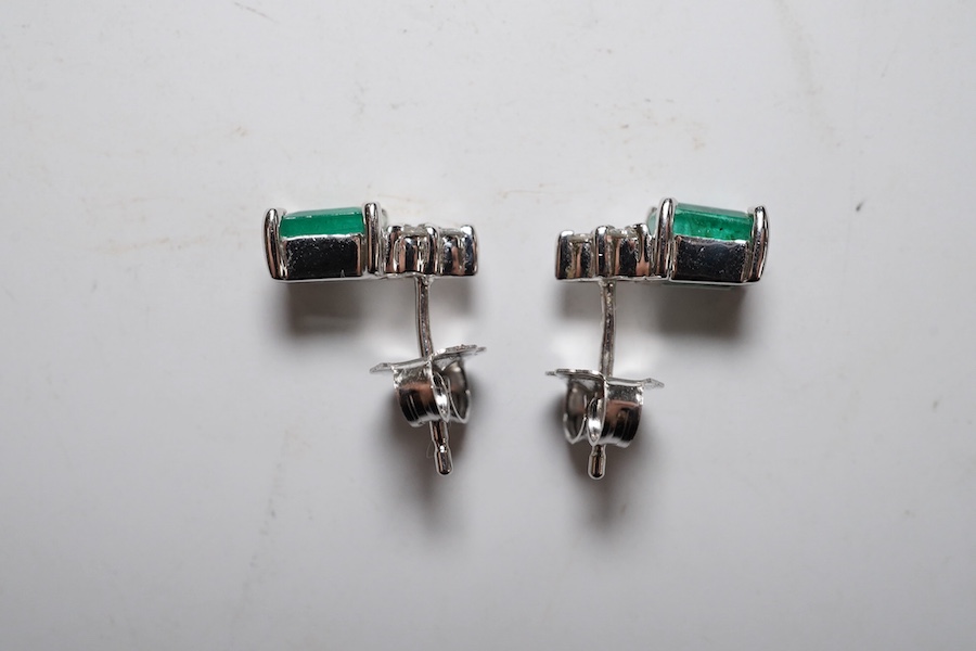 A small modern pair of 14k white metal, emerald and diamond cluster set ear studs, 9mm, gross weight 1.4 grams. Condition - good